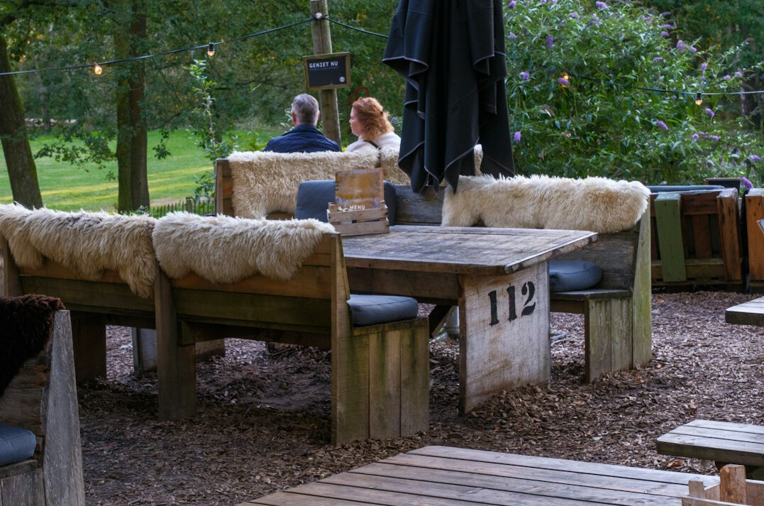 Small group working together with laptops at a wooden table
